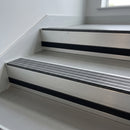 Granite Castellated insert in a 66x55mm square front aluminium stair nosing with 13mm black riser highlight, fitted to interior steps