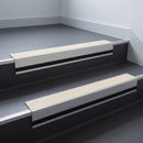 Ivory Castellated insert in a 66x55mm square front aluminium stair nosing with 13mm black riser highlight, fitted to interior steps