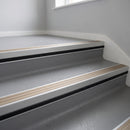 Light Bronze Aluminium insert in a 66x55mm square front aluminium stair nosing with 13mm black riser highlight, fitted to interior steps