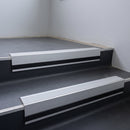 Light Grey Smooth Textured insert in a cut to size 66x55mm aluminium stair nosing with 13mm black riser highlight, fitted to interior steps