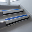 Mid Blue Castellated insert in a cut to size 66x55mm aluminium stair nosing with 13mm black riser highlight, fitted to interior steps