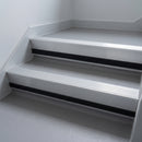 Mill Aluminium insert in a 66x55mm square front aluminium stair nosing with 13mm black riser highlight, fitted to interior steps