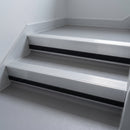 Mill Aluminium insert in a cut to size 66x55mm aluminium stair nosing with 13mm black riser highlight, fitted to interior steps
