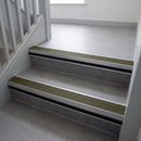 Olive Castellated insert in a cut to size 66x55mm aluminium stair nosing with 13mm black riser highlight, fitted to interior steps