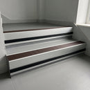 Peat Castellated insert in a cut to size 66x55mm aluminium stair nosing with 13mm black riser highlight, fitted to interior steps