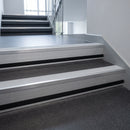 Polar Grey Castellated insert in a 66x55mm square front aluminium stair nosing with 13mm black riser highlight, fitted to interior steps