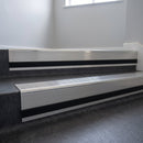 Polished Aluminium insert in a cut to size 66x55mm aluminium stair nosing with 13mm black riser highlight, fitted to interior steps