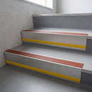 Rustic Castellated insert in a cut to size 66x55mm aluminium stair nosing with 13mm Yellow riser highlight, fitted to interior steps