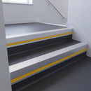 Satin Aluminium insert in a cut to size 66x55mm aluminium stair nosing with 13mm Yellow riser highlight, fitted to interior steps