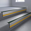 Spruce Castellated insert in a 66x55mm square front aluminium stair nosing with 13mm Yellow riser highlight, fitted to interior steps