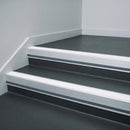 White Castellated insert in a 66x55mm square front aluminium stair nosing with 13mm Light Grey riser highlight, fitted to interior steps