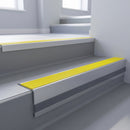 Yellow Castellated insert in a 66x55mm square front aluminium stair nosing with 13mm Light Grey riser highlight, fitted to interior steps