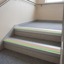 Aluminium stair nosing with beige PVC insert and green photoluminescent strip fitted on commercial stairs