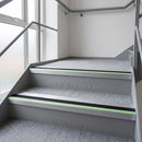 Aluminium stair nosing with black PVC insert and green photoluminescent strip fitted on office stairs