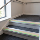 Aluminium stair nosing with canvas PVC insert and green photoluminescent strip fitted on commercial stairs