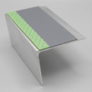 67x55mm rake back aluminium stair nosing profile showing the green photoluminescent strip and grey PVC insert