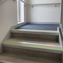 Square edge aluminium stair nosing with beige PVC insert and green photoluminescent strip fitted on care home stairs