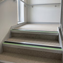 Square edge aluminium stair nosing with black PVC insert and green photoluminescent strip fitted on office stairs