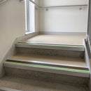 Square edge aluminium stair nosing with brown PVC insert and green photoluminescent strip fitted on communal stairs