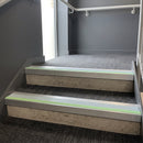 Square edge aluminium stair nosing with ice grey PVC insert and green photoluminescent strip fitted on office reception stairs