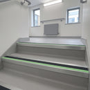 Square edge aluminium stair nosing with midnight grey PVC insert and green photoluminescent strip fitted on hospital stairs