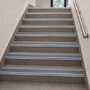 Aluminium stair nosings with cobalt blue anti-slip PVC inserts fitted along an internal tiled staircase