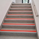 Aluminium stair nosings with red anti-slip PVC inserts marking every step edge on an internal staircase