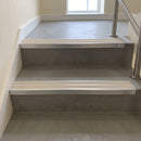Beige twin insert 88x32mm aluminium stair nosing fitted to grey concrete commercial steps