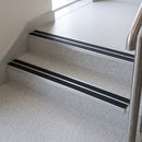 Black twin insert 88x32mm aluminium stair nosings fitted to terrazzo school steps, two anti-slip bands split by a mill aluminium rib