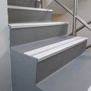 White twin insert 88x32mm aluminium stair nosing fitted to grey concrete commercial steps