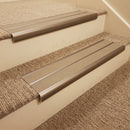 Dark bronze aluminium bullnose stair nosing with twin beige inserts fitted to a hotel corridor step