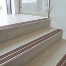 Brown double insert 91x32mm aluminium stair nosing fitted to concrete office steps in a glazed stairwell