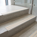 Canvas double insert 91x32mm aluminium stair nosing fitted to concrete office steps in a glazed stairwell