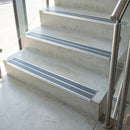 Midnight Grey double insert 91x32mm aluminium stair nosing fitted to concrete office steps in a glazed stairwell