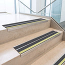 Midnight Grey double insert 91x32mm aluminium stair nosing fitted to concrete office steps with a green photoluminescent nose strip
