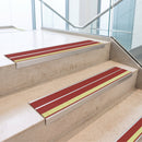 Red double insert 91x32mm aluminium stair nosing fitted to concrete office steps with a green photoluminescent nose strip