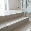 White double insert 91x32mm aluminium stair nosing fitted to concrete office steps in a glazed stairwell