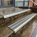 Dolphin Grey Tredsafe 91x32mm aluminium stair nosing fitted to wet exterior entrance steps with a green photoluminescent nose strip