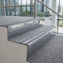 Bright polished aluminium chevron stair nosing with twin mid grey inserts fitted to two carpeted office stairwell steps