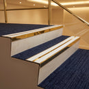 Mirrorflect gold aluminium chevron stair nosing with twin white inserts fitted to two carpeted hotel lobby steps