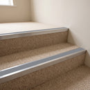 Mill finish square aluminium stair nosing with Mid Grey insert fitted to beige carpeted office stairs