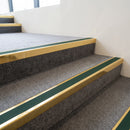 Mirrorflect gold aluminium stair nosing with Dark Green insert fitted to grey carpeted department store stairs