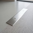 82mm mill aluminium cover plate with a smooth top face screw fitted between resin and vinyl flooring
