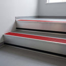 Poppy Castellated insert in a 66x55mm square front aluminium stair nosing with 13mm black riser highlight, cut to size and fitted to interior office steps