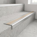 Slimline raked back 59x30mm aluminium stair nosing with a light bronze anodised aluminium insert, on a satin aluminium bar, fitted directly to a bare concrete step