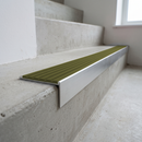 Slimline raked back 59x30mm aluminium stair nosing with an olive khaki ribbed PVC insert, on a satin aluminium bar, fitted directly to a bare concrete step