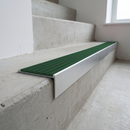 Slimline raked back 59x30mm aluminium stair nosing with a spruce forest-green ribbed PVC insert, on a satin aluminium bar, fitted directly to a bare concrete step