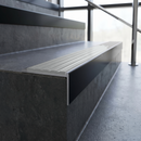 Slimline 59x30mm square back aluminium stair nosing with a pale polar grey ribbed PVC insert, on a black anodised bar, fitted along the front edge of a concrete step