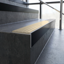 Slimline 59x30mm square back aluminium stair nosing with a pale Porth Stone ribbed PVC insert, on a black anodised bar, fitted along the front edge of a concrete step