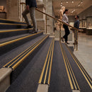 Anodised aluminium stair nosing 35x19mm with twin black rubber inserts on a plain studio background